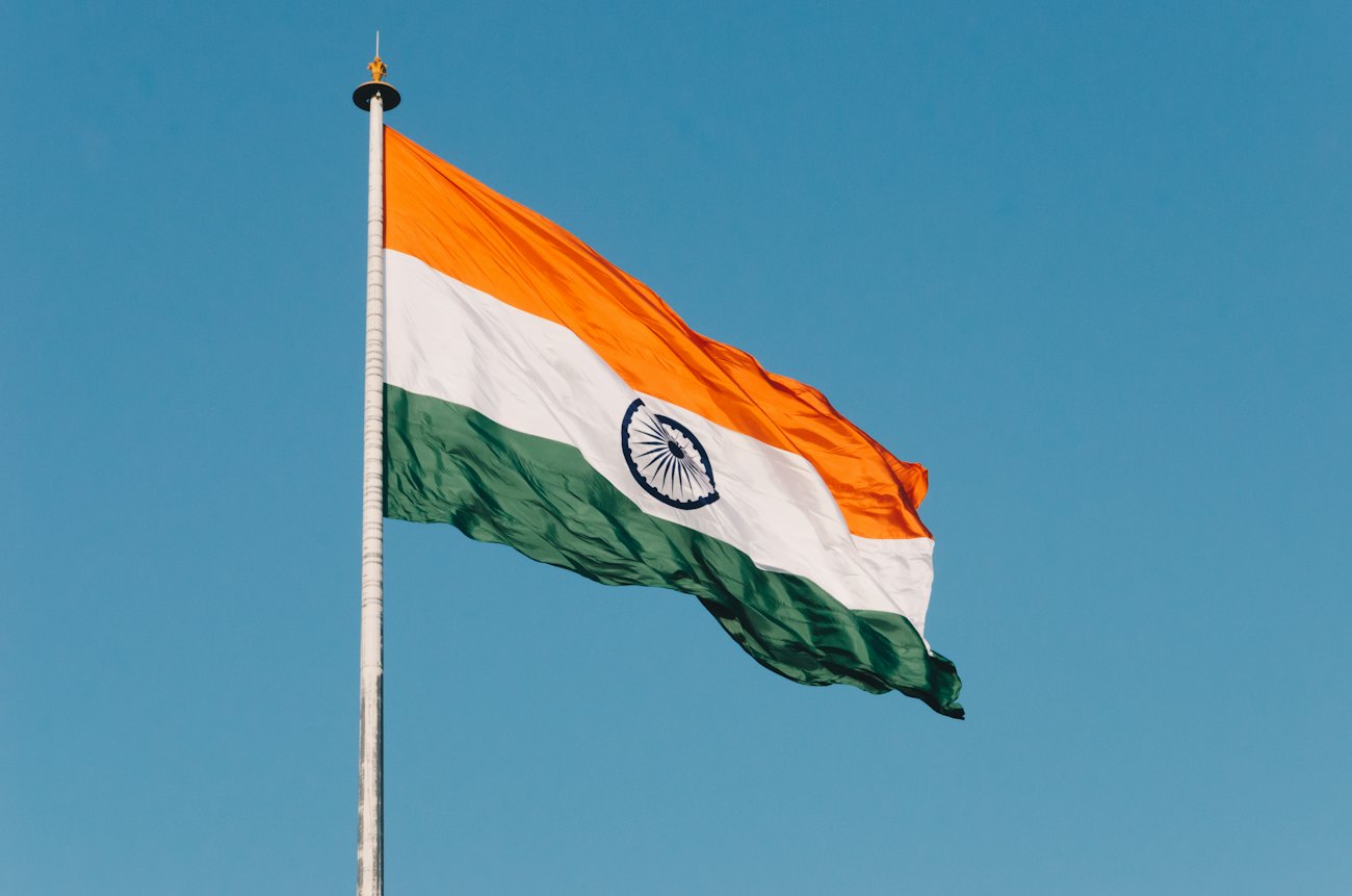 The Indian tricolour flying against a blue sky
