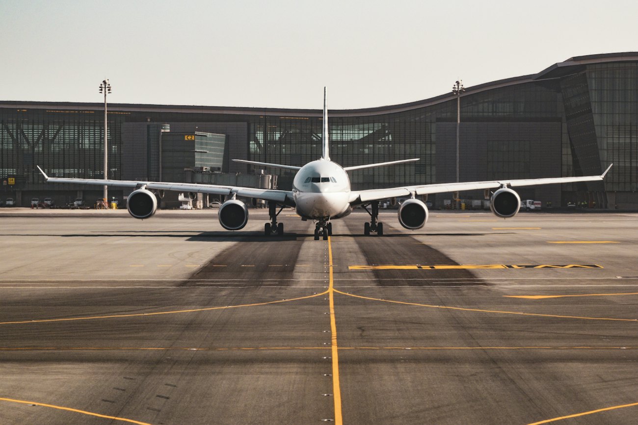 An aircraft parked at the gate under a clear sky