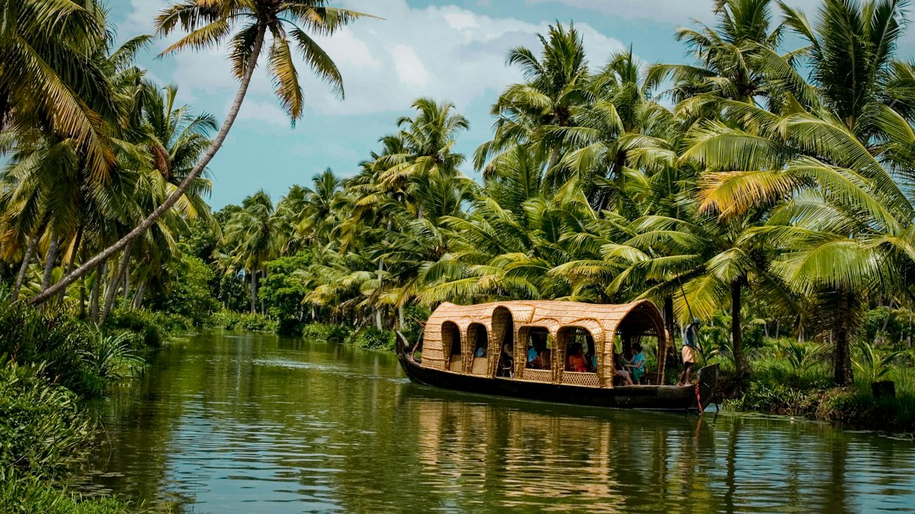 A traditional houseboat drifting through the Kerala backwaters